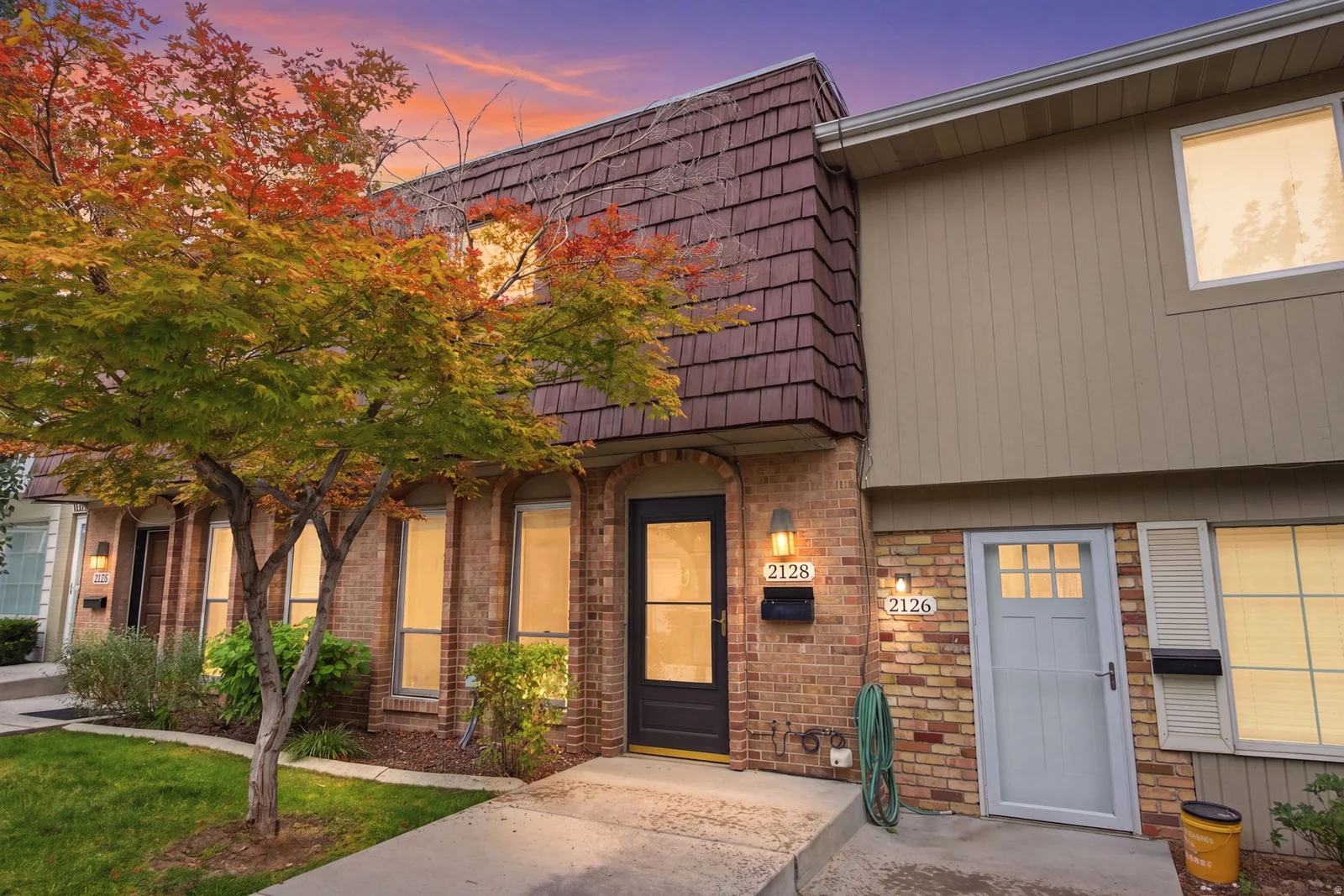 Brick and siding exterior with a textured shingle roofline